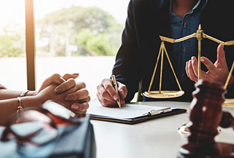 5-State-Bar Close-up of lawyer talking to client with scales on the table between them