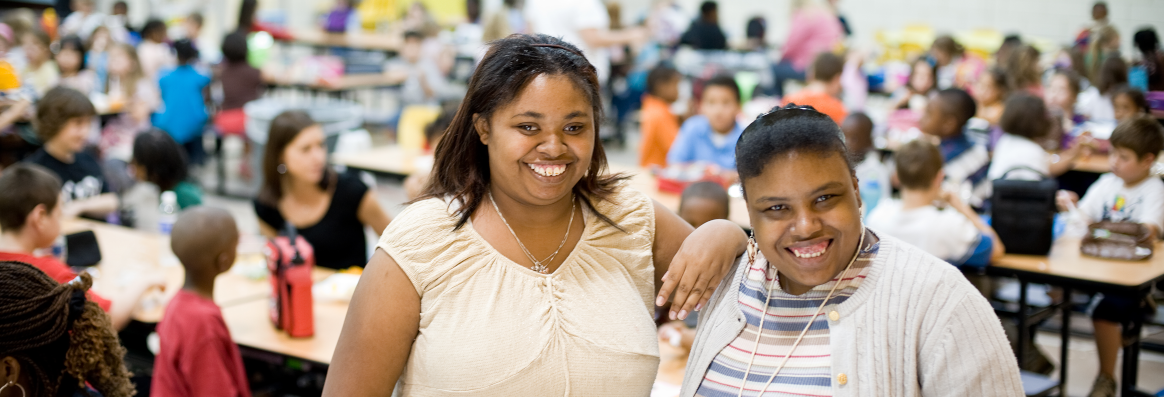 Two Smiling in cafeteria