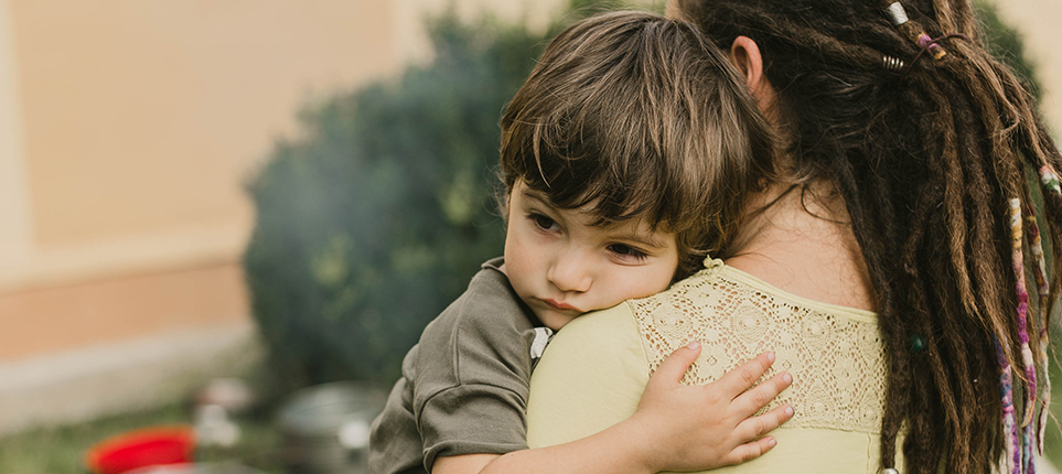 4 Flex Space A woman holds a young toddler boy as he wraps his arm around her shoulder