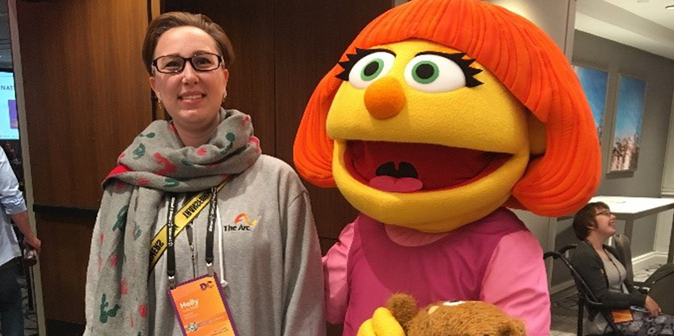 molly Convention attendee stands and poses with Muppet from Sesame Street